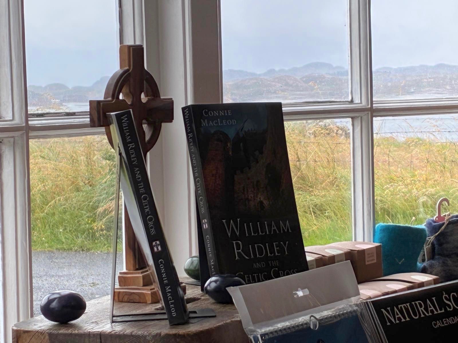 William Ridley and the Celtic Cross displayed in the bay window of Iona Community Welcome Centre Book Shop.